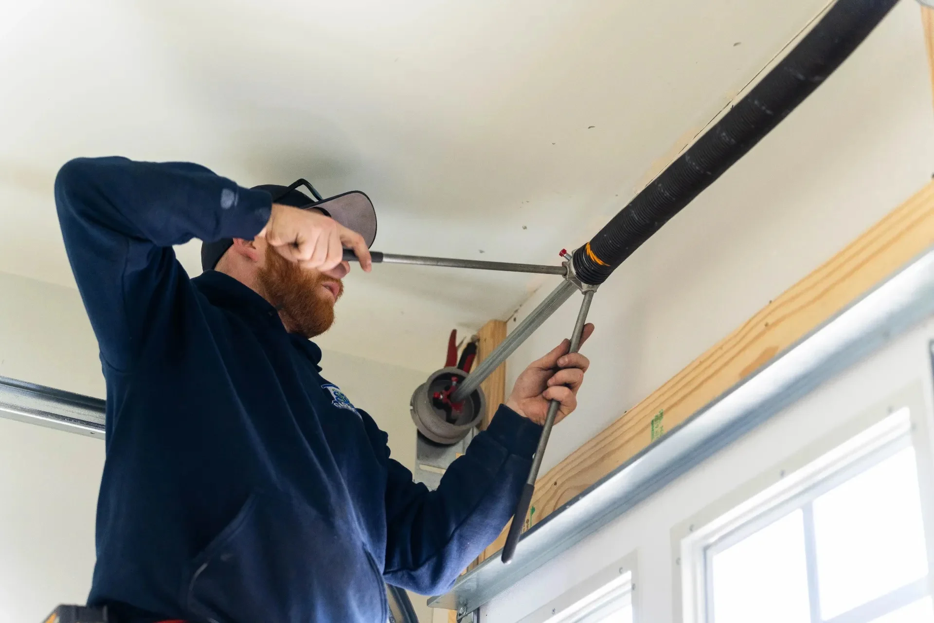 Garage door spring system being inspected